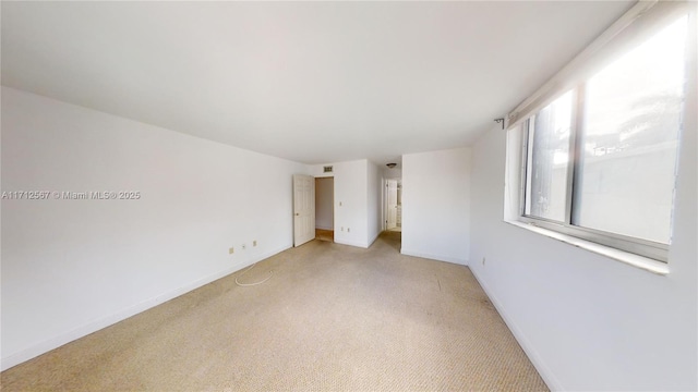 unfurnished bedroom featuring light carpet