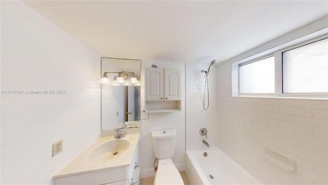 full bathroom featuring vanity, tiled shower / bath combo, and toilet