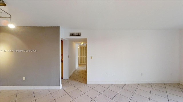 spare room featuring light tile patterned floors