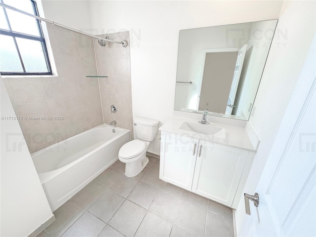 full bathroom featuring tile patterned flooring, vanity, toilet, and tiled shower / bath