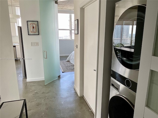 laundry room featuring laundry area and stacked washer / dryer