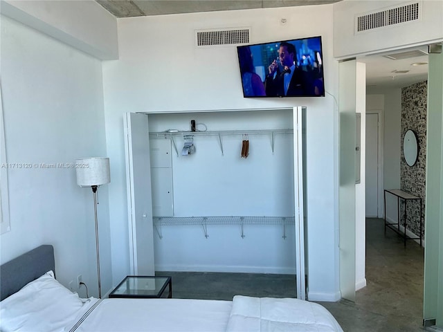 bedroom featuring visible vents and concrete flooring