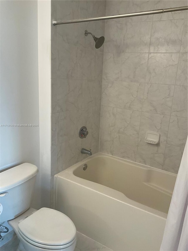 full bathroom featuring shower / tub combo and toilet