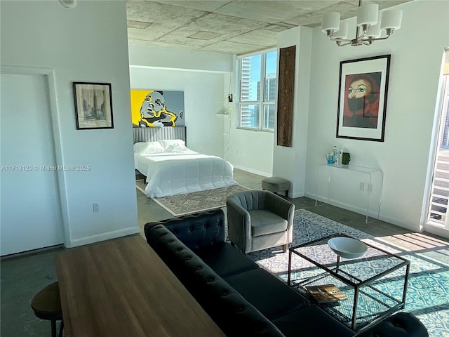 bedroom featuring a chandelier and baseboards