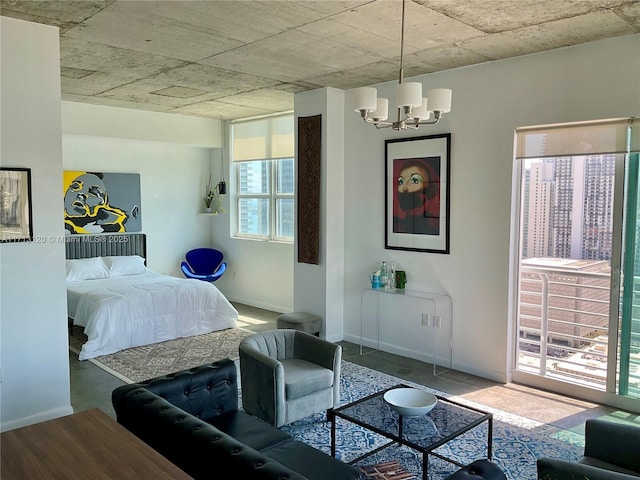 bedroom with a chandelier and baseboards