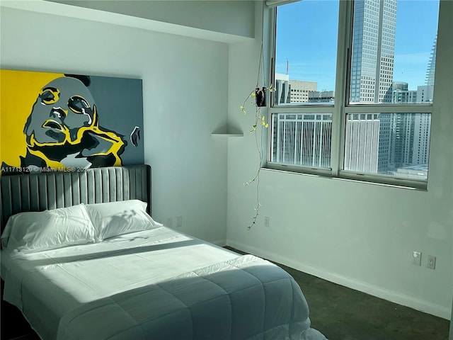 bedroom with a view of city and baseboards