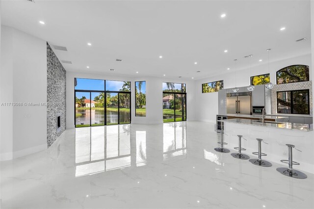 unfurnished living room featuring sink and beverage cooler