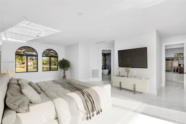 bedroom featuring ensuite bathroom and built in fridge