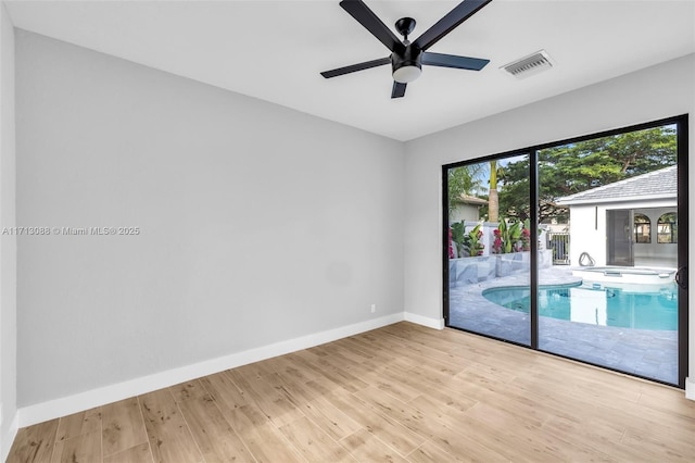 spare room with ceiling fan and light hardwood / wood-style floors