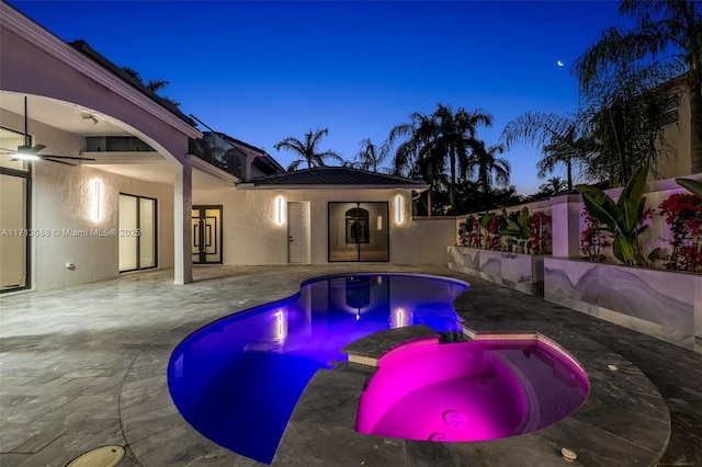 view of pool with a pool with connected hot tub, a patio, and french doors