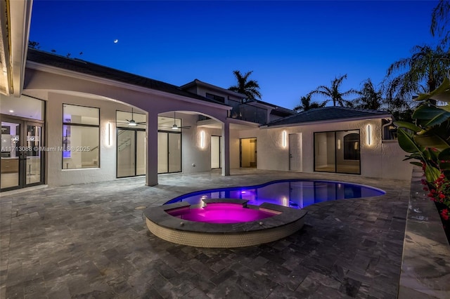 view of pool featuring a patio area and an in ground hot tub