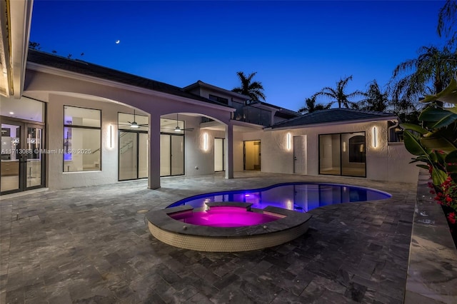 view of pool featuring ceiling fan, a pool with connected hot tub, and a patio