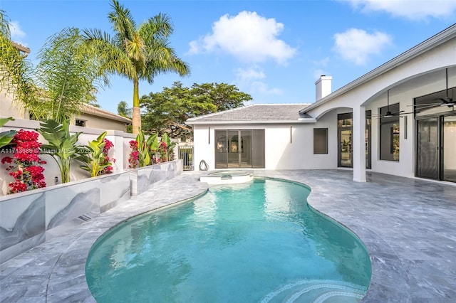 view of swimming pool with a patio, ceiling fan, a fenced backyard, and a pool with connected hot tub