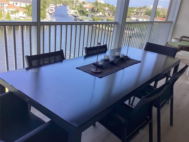 exterior space featuring wood finished floors and a water view