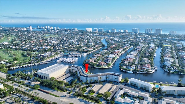 drone / aerial view with a city view and a water view