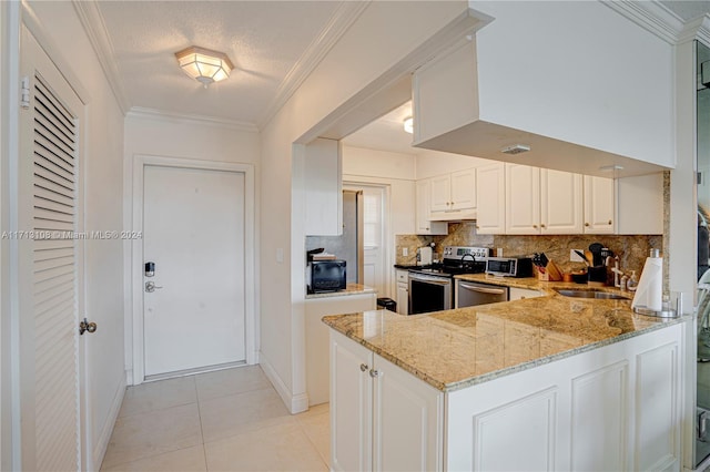 kitchen featuring light stone countertops, stainless steel appliances, kitchen peninsula, white cabinets, and ornamental molding