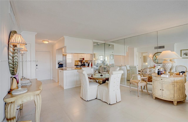 dining area with a textured ceiling and crown molding