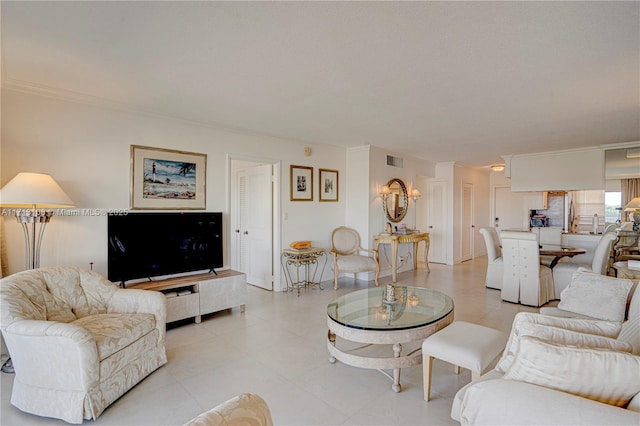 living room featuring visible vents and ornamental molding