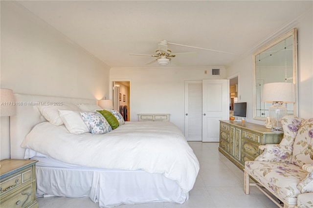 bedroom with a closet, light tile patterned floors, ceiling fan, ornamental molding, and visible vents