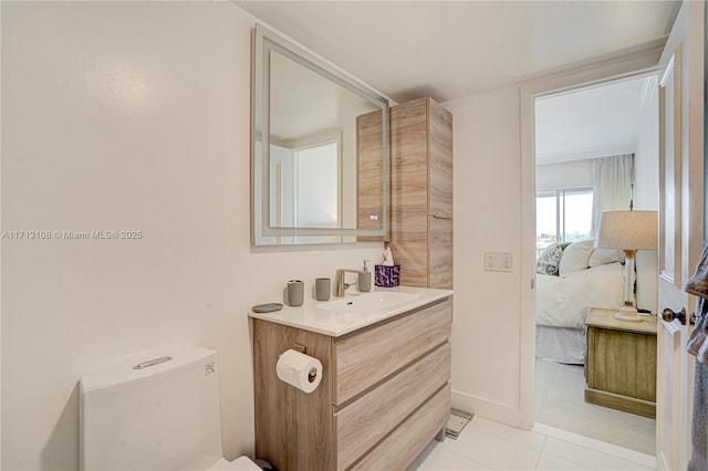 bathroom with tile patterned flooring, vanity, connected bathroom, and toilet