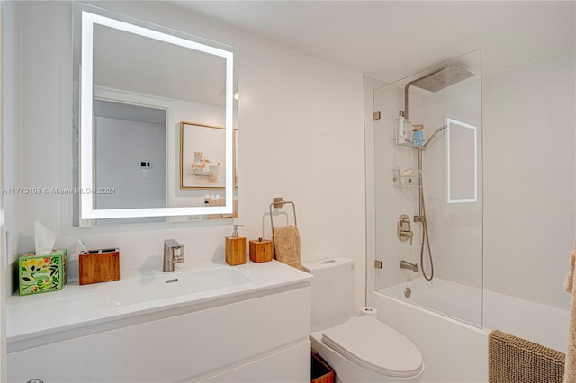 full bathroom with vanity, tiled shower / bath combo, and toilet