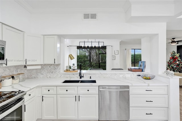 kitchen featuring white cabinetry, sink, light stone counters, kitchen peninsula, and appliances with stainless steel finishes