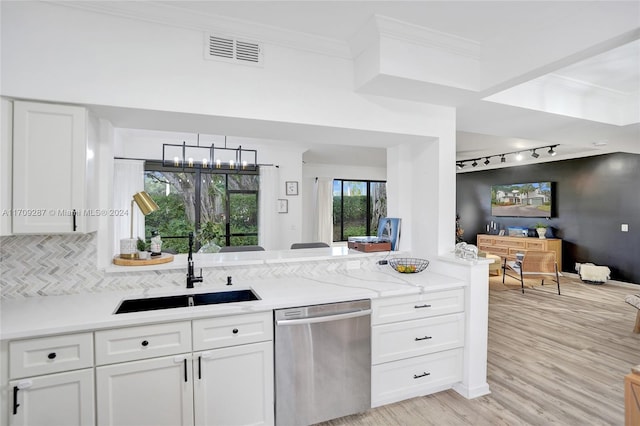 kitchen featuring white cabinetry, sink, stainless steel dishwasher, and light wood-type flooring