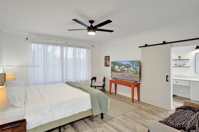 bedroom with ceiling fan, a barn door, ornamental molding, and light hardwood / wood-style flooring