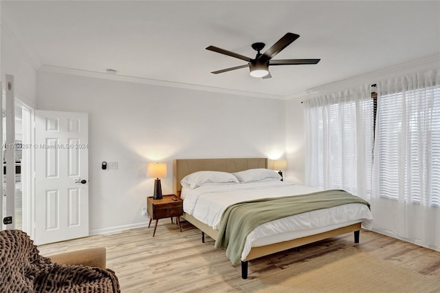 bedroom with light wood-type flooring, multiple windows, crown molding, and ceiling fan