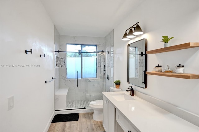 bathroom with vanity, hardwood / wood-style flooring, toilet, and walk in shower