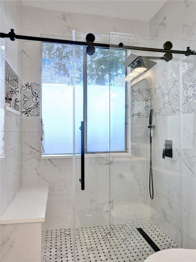 bathroom with a shower with door