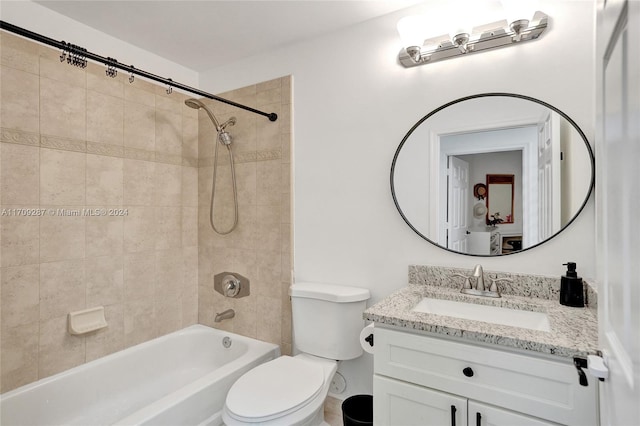 full bathroom with toilet, vanity, and tiled shower / bath