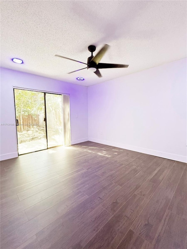 spare room with dark hardwood / wood-style floors, ceiling fan, and a textured ceiling