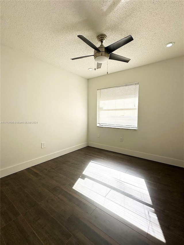 spare room featuring a textured ceiling, dark hardwood / wood-style floors, and ceiling fan