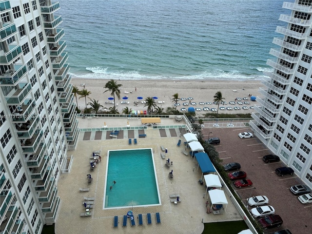 bird's eye view featuring a water view and a view of the beach