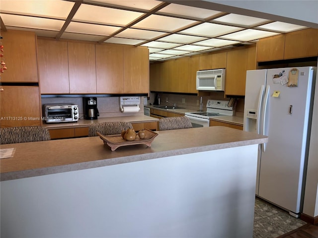 kitchen featuring dark hardwood / wood-style flooring and white appliances