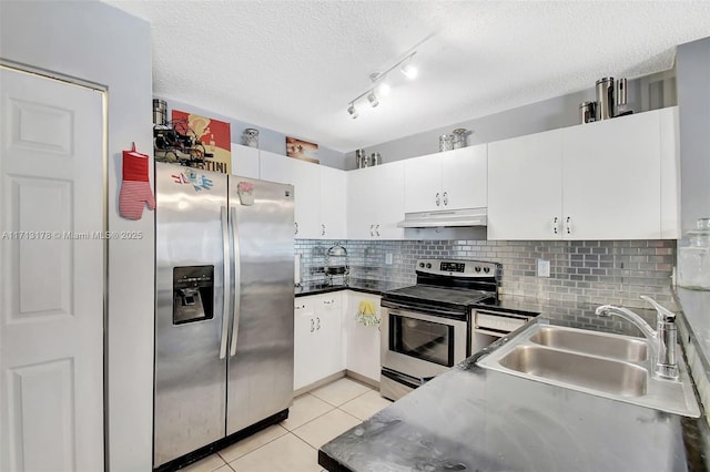 kitchen with light tile patterned floors, a sink, decorative backsplash, stainless steel appliances, and under cabinet range hood