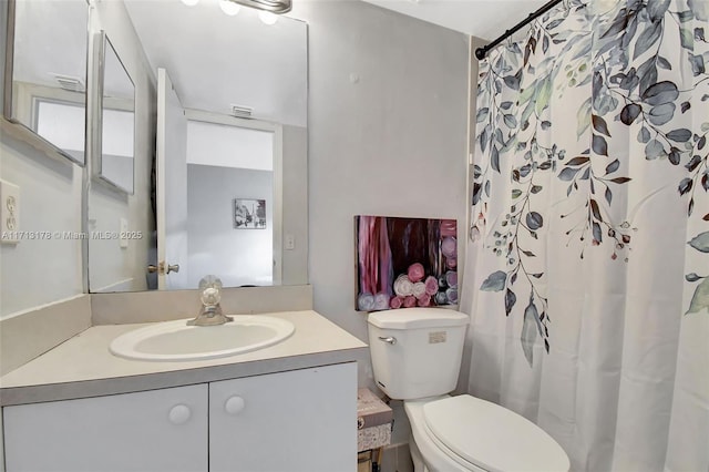 full bathroom with toilet, vanity, and a shower with shower curtain