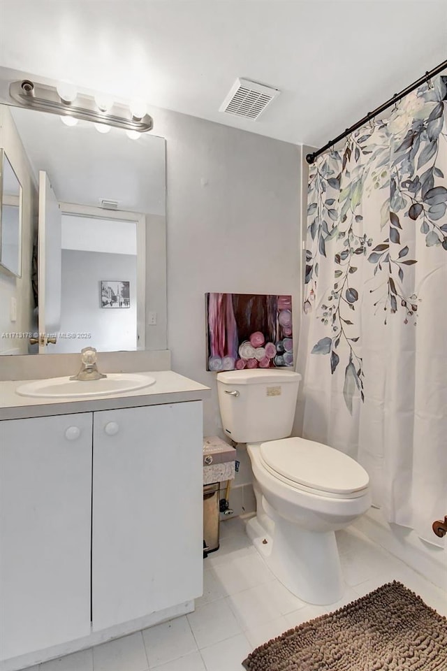 bathroom with visible vents, toilet, a shower with shower curtain, tile patterned floors, and vanity