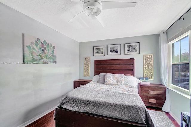 bedroom featuring ceiling fan, baseboards, and wood finished floors