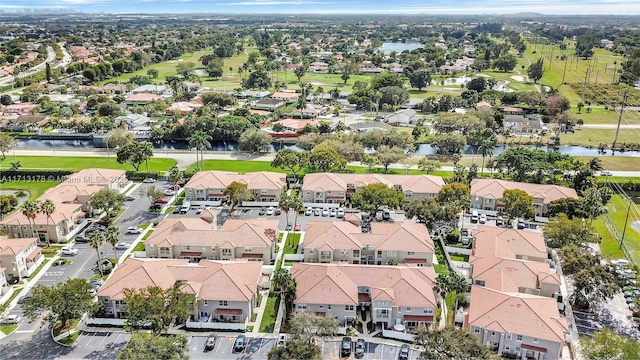 aerial view featuring a residential view, golf course view, and a water view