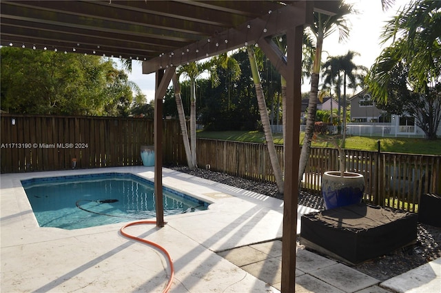 view of swimming pool featuring a patio area and a pergola