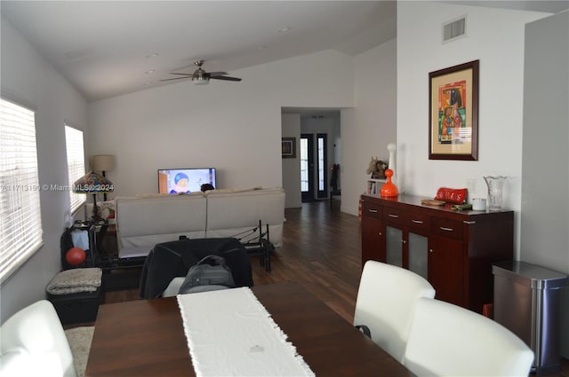 dining space with dark hardwood / wood-style flooring, ceiling fan, and lofted ceiling