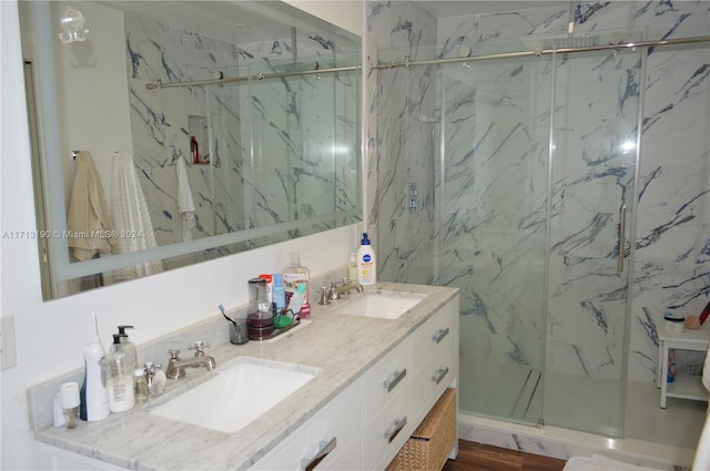 bathroom featuring a shower with door, vanity, and wood-type flooring