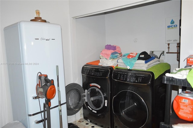 washroom featuring separate washer and dryer and water heater