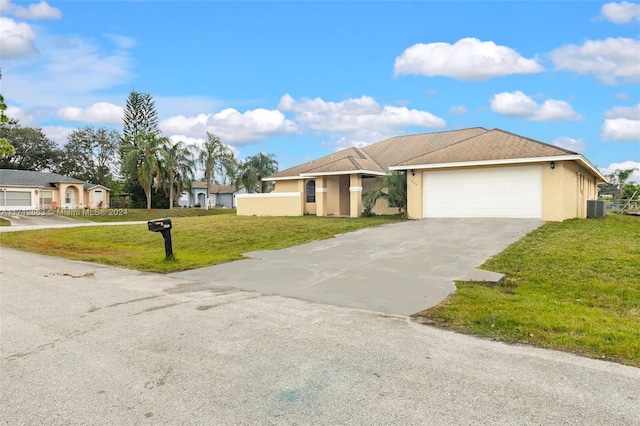 view of front of home featuring a front lawn, cooling unit, and a garage