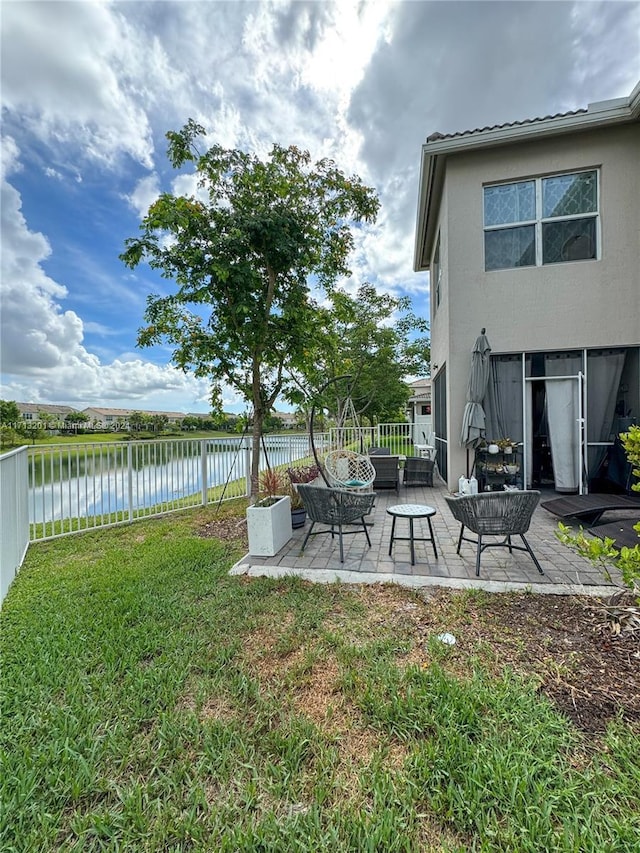 view of yard with a water view, an outdoor hangout area, and a patio