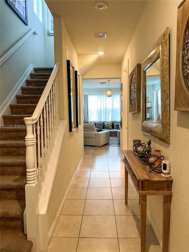 hall featuring light tile patterned flooring