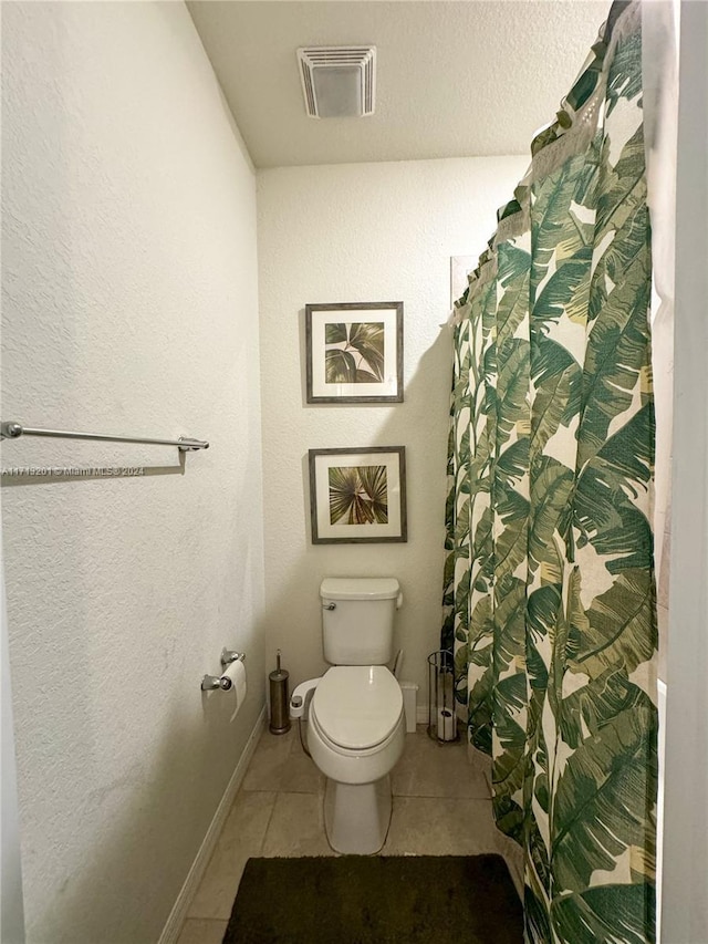 bathroom featuring tile patterned floors and toilet