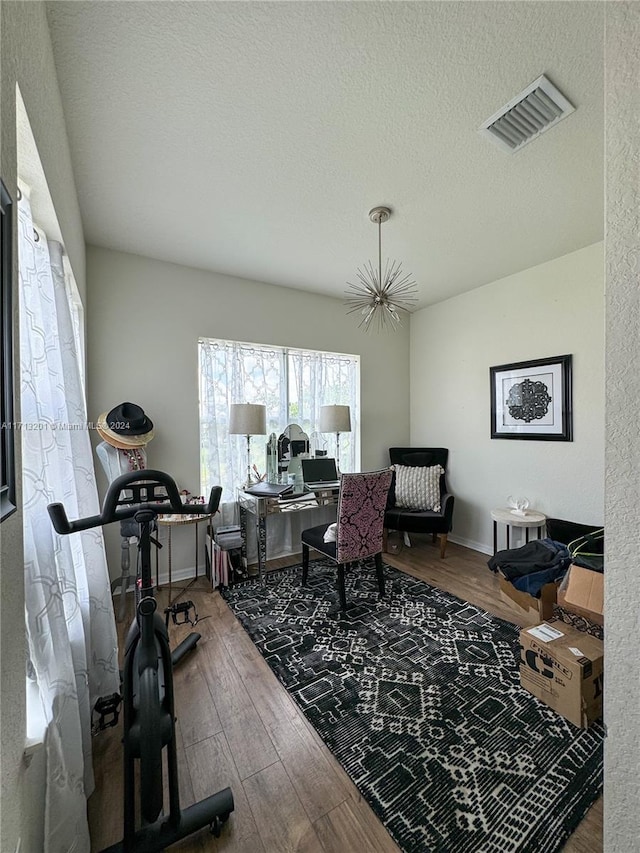 office area with hardwood / wood-style flooring and a textured ceiling